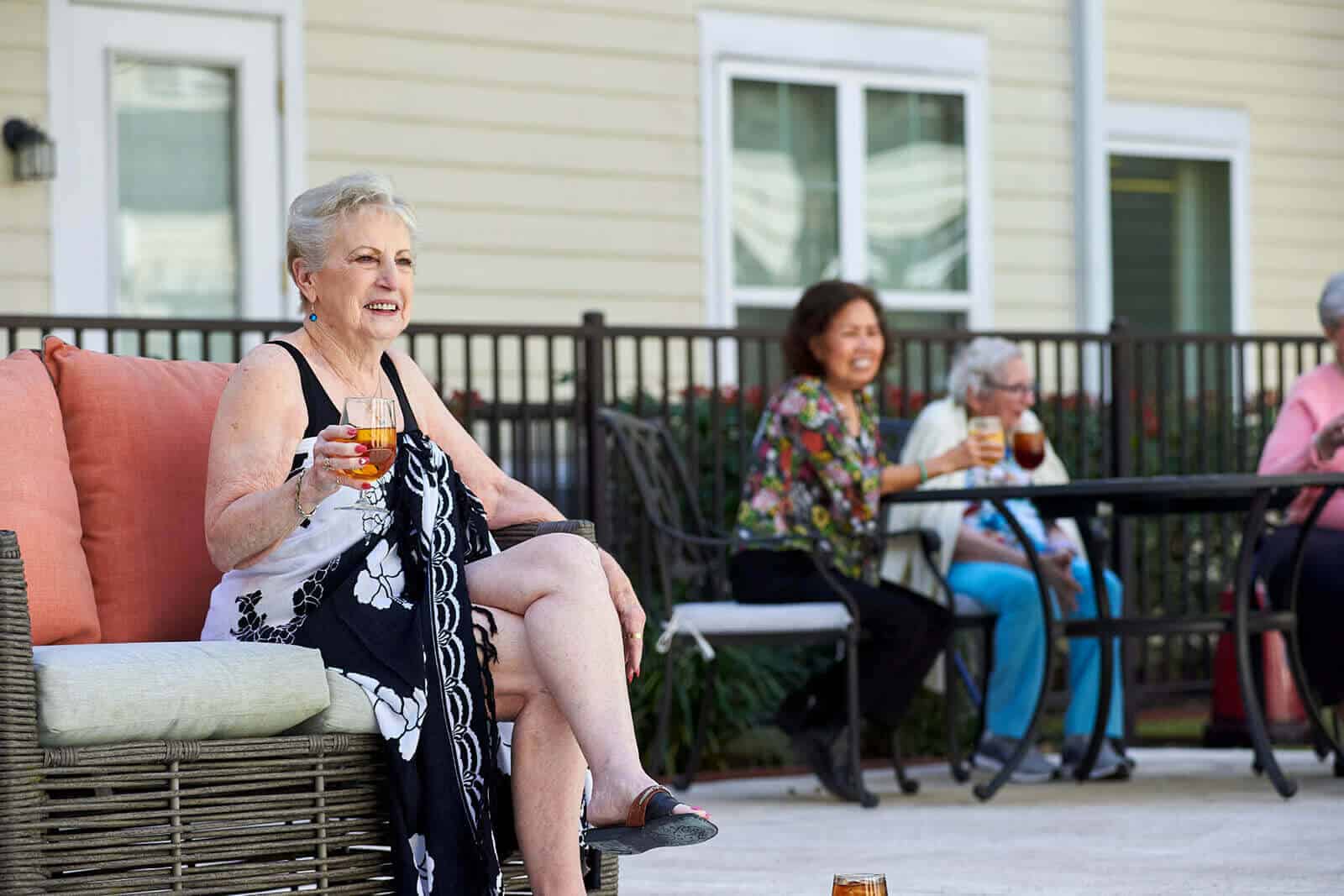 residents enjoying drinks by the pool