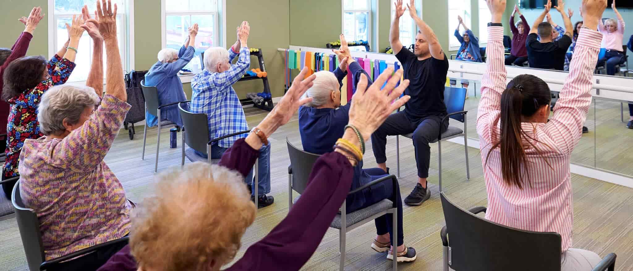 Seniors Taking a Chair Exercise Class
